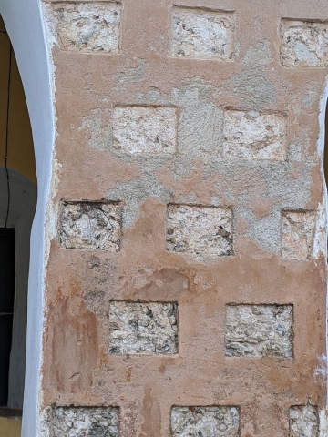Closeup of squares filled with cement that make up the building structure.
